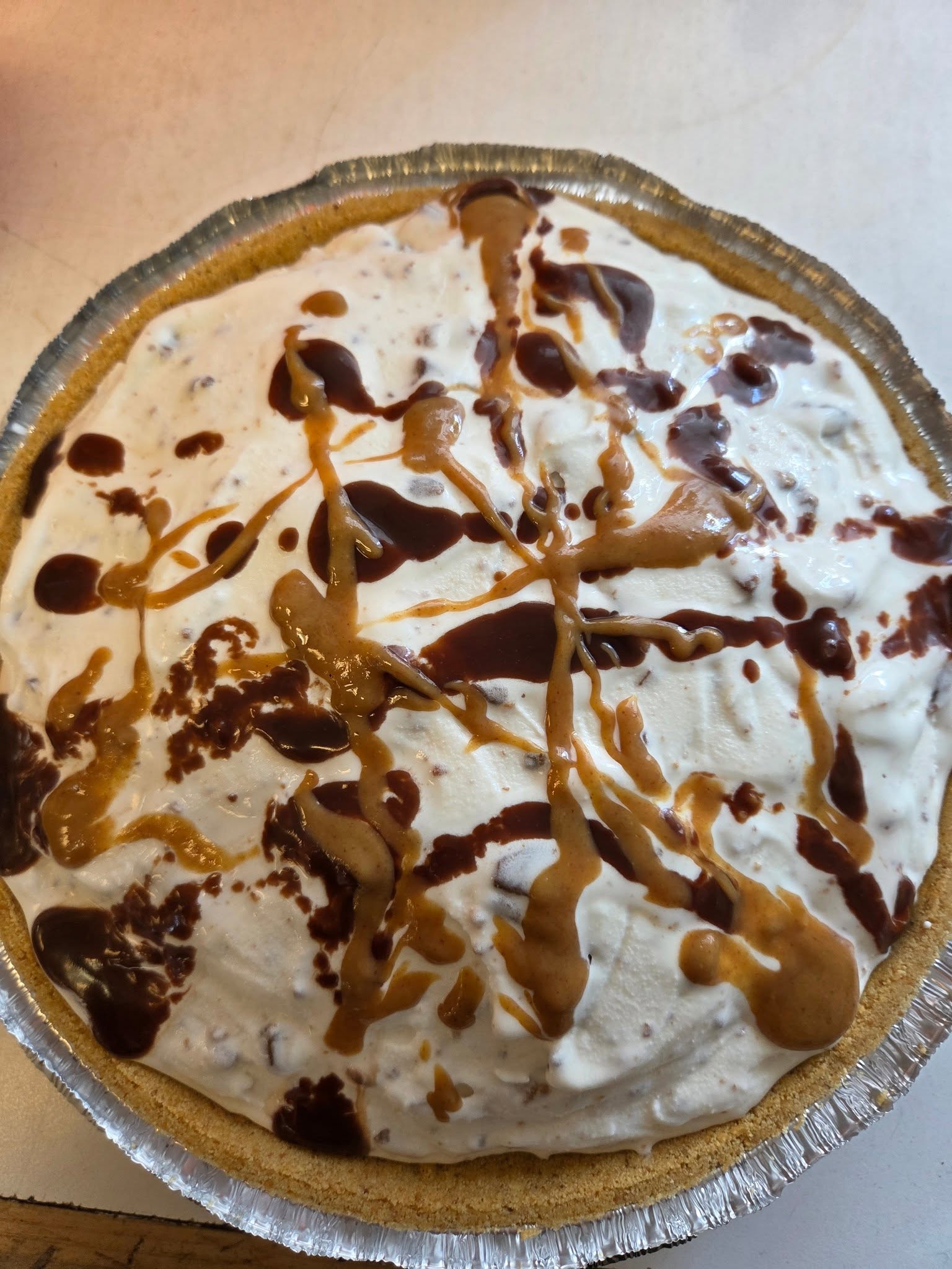 Ice cream pie with caramel and chocolate drizzle